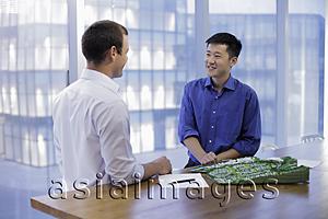 Asia Images Group - Young men talking during business meeting