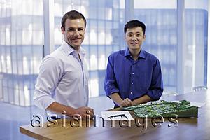 Asia Images Group - Young men smiling during business meeting.