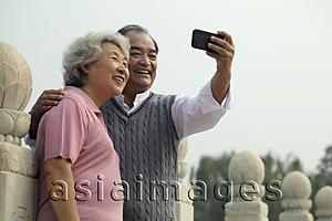 Asia Images Group - Older couple smiling and taking a photo of each other
