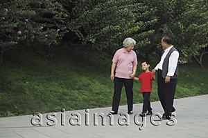 Asia Images Group - Older couple walking with grandson in the park