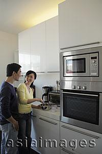 Asia Images Group - Couple cooking together in kitchen