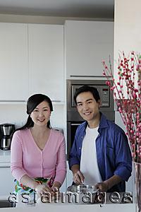 Asia Images Group - Couple cooking in kitchen together