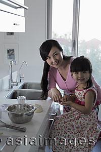 Asia Images Group - Mother teaching daughter how to cook