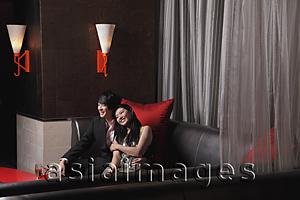Asia Images Group - Young couple sitting together at a club
