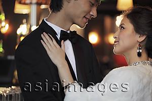 Asia Images Group - Profile of an elegantly dressed young couple looking at each other