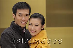 Asia Images Group - Head shot of smiling young couple hugging