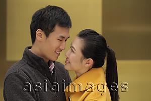 Asia Images Group - Young couple looking at each other and smiling