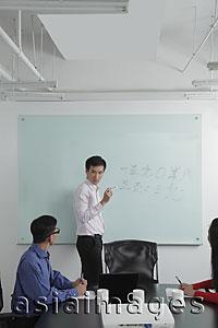 Asia Images Group - Man giving a presentation during a meeting