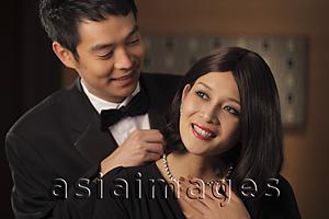 Asia Images Group - Young man putting a diamond necklace onto a woman