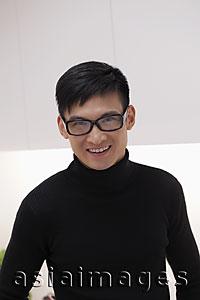 Asia Images Group - Headshot of young man wearing glasses and smiling