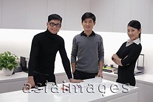 Asia Images Group - Three people working together in modern office building
