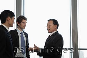 Asia Images Group - Businessman talking to younger excutives