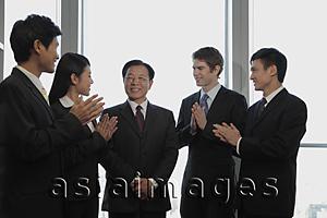 Asia Images Group - Small group of business people smiling and clapping