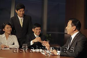 Asia Images Group - People smiling during a business meeting