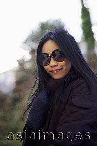 Asia Images Group - Woman wearing large sunglass and smiling outdoors