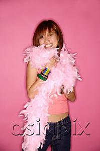 AsiaPix - Young woman looking at camera, wearing feather boa