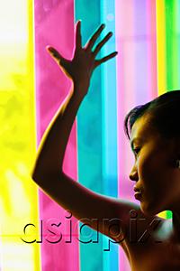 AsiaPix - Woman leaning hand against coloured glass