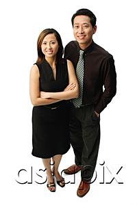 AsiaPix - Couple standing, smiling at camera, woman with arms crossed