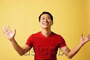 AsiaPix - Man smiling, looking up, arms outstretched