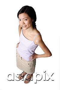 AsiaPix - Young woman smiling at camera, hands on hips