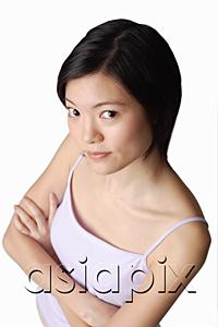 AsiaPix - Young woman looking at camera, arms crossed