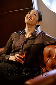 AsiaPix - Woman with champagne glass, looking up, smiling