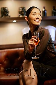AsiaPix - Woman with champagne glass, smiling, looking away