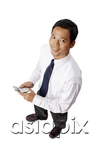 AsiaPix - Young executive, holding mobile phone, looking at camera