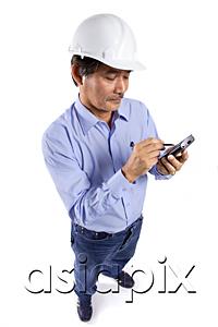 AsiaPix - Mature man wearing construction hat, using PDA