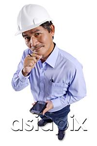 AsiaPix - Mature man wearing construction hat, holding PDA, hand on chin, looking at camera