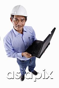 AsiaPix - Mature man wearing construction hat, holding laptop, looking at camera