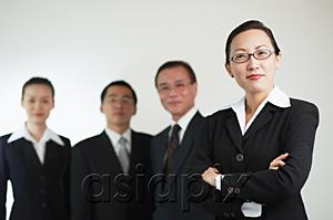 AsiaPix - Businesswoman with arms crossed, other executives in the background