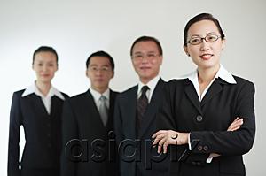 AsiaPix - Businesswoman with arms crossed, other executives in the background