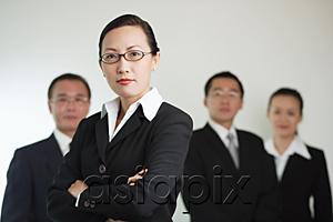 AsiaPix - Group of businesspeople, businesswoman in the foreground with arms crossed