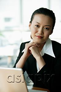 AsiaPix - Businesswoman looking at camera, hands clasped