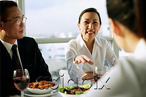 AsiaPix - Executives having lunch, woman gesturing with hand