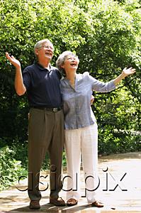 AsiaPix - Senior couple looking up, hands outstretched