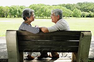 AsiaPix - Mature couple sitting face to face on park bench