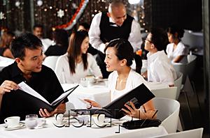 AsiaPix - Couple in restaurant, looking at menus