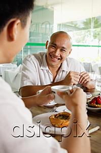 AsiaPix - Two men at a cafe, eating, over the shoulder view