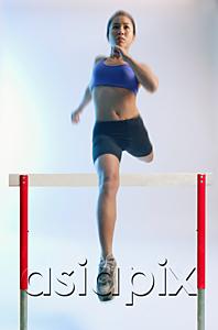 AsiaPix - Woman running and jumping over hurdle