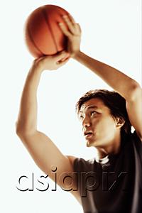 AsiaPix - Man aiming basketball, looking away
