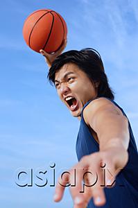AsiaPix - Man holding basketball in the air, mouth open