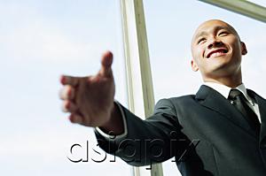 AsiaPix - Businessman, hand outstretched, smiling