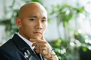 AsiaPix - Businessman, hand on chin, looking at camera