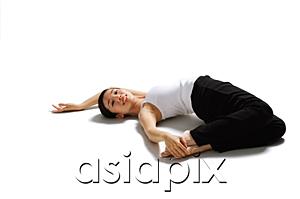 AsiaPix - Woman lying on back, pulling feet towards her, looking at camera