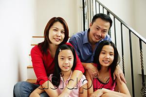 AsiaPix - Family of four sitting on stairs, looking at camera, family portrait