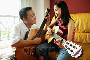 AsiaPix - Father and daughter holding guitars