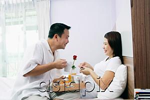 AsiaPix - Couple in bedroom, breakfast tray between them