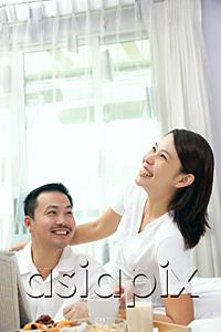 AsiaPix - Couple in bedroom, breakfast tray on bed, woman smiling, looking up